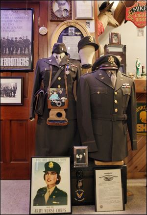 A US Army Air Corps Flight Nurse uniform that Mary Kay Hickey, Mike McMahon's aunt wore in 1944, left, and a 1944 US Army Air Corps uniform his father, Edmond T. McMahon wore, in the collection of military items.