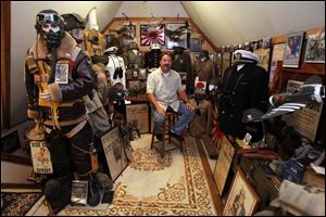 Mike McMahon with a small part oh his collection of military items on the third floor of his home in the Old West End on May 17, 2012.