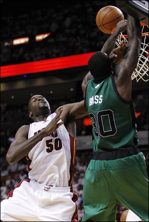 The Heat's Joel Anthony (50) blocks a shot by the Celtics' Brandon Bass (30) during the second half of Game 2 in their NBA basketball Eastern Conference finals playoffs series Wednesday.