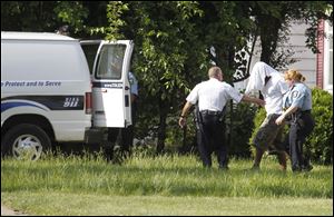 A man is removed from a home on Keil Road near Avondale following a standoff with Toledo Police.