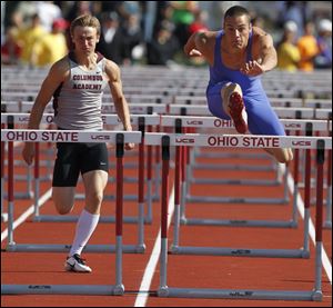 Liberty-Benton’s Dakota Conkle flies over a hurdle en route to capturing a title in the 110-meter high hurdles. He missed his junior track season because of an injury. He was third in the event as a sophomore.