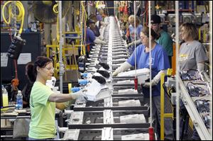Employees work the assembly line at Whirlpool in Clyde, Ohio, where the company builds high-efficiency washing machines.