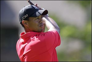 Tiger Woods tees off on the 18th hole during the final round of the Memorial golf tournament in Dublin, Ohio. Woods birdied the hole.