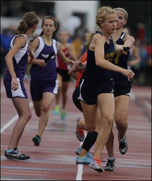 Toledo Christian's Krista Wood takes the baton from Darian Westmeyer. Along with Delainey Phelps and Michelle Wright, they won the 3200-meter relay at the Division III state meet in Columbus.