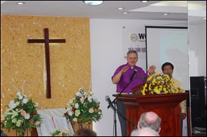 Bishop Bruce Ough addresses a congregation in Vietnam, where he aided in dedicating a new United Methodist center.