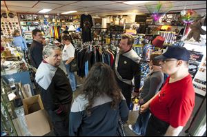 Thomas Patton, center, dressed as a Star Fleet captain, talks with shoppers and 'Star Trek' fans at Star Base Columbus in the suburb of Blendon Township. The store, a base for all things fantasy and science fiction, is celebrating its 20th anniversary on Saturday. Local fan clubs also meet at the location.