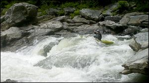 A kayaker paddles through rapids on Section IV of the Chattooga River in Georgia, the famed section where much of the movie ‘Deliverance’ was filmed. This summer marks the 40th anniversary of the landmark film.