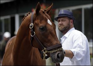 Kentucky Derby and Preakness winner I’ll Have Another stands with trainer Doug O’Neill during a Friday news conference.