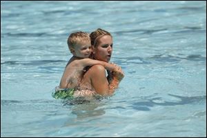 Two-year-old Trenton Falknor gets a ride on the mother of his shoulder, Melissa Falknor, of Perrysburg.