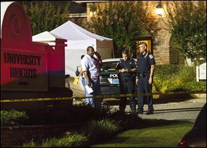 Auburn Police cordon off the scene at University Heights apartment complex on West Longleaf Drive, early Sunday in Auburn, Alabama. Auburn's Police Chief Tommy Dawson  says several people have been shot at an apartment complex in the city.