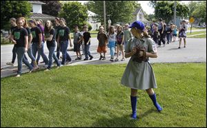 Madison Lein, 14, portrays professional female baseball player Betty Whiting as Ida Elementary School students are led on an historical tour of Ida, Mich., led by students from the Ida Middle School MS Backyard History Class.   Whiting, an Ida native, was a utility who played from 1944 through 1952 in the All-American Girls Professional Baseball League. 