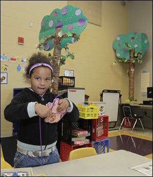 Kindergartner Jaih’shawn’da Barnett demonstrates her fine motor skills. Robinson was a junior high school until offering kindergarten through eighth grade this year.