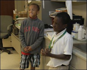 Third graders A’Maun Knowles and Marquan Whitiker, in the school nurse’s office, are ready for vacation. A’Maun was there Tuesday to get a bandage.