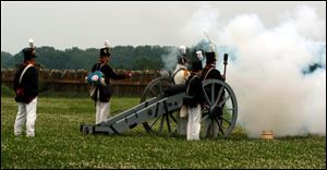Re-enactors at Fort Meigs demonstrate how a cannon
was fired during the War of 1812.