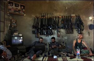 Syrian rebel soldiers wait in a house on the outskirts of Aleppo, the nation's largest city. Escalating violence has prompted calls from the U.N. special envoy for influential nations to 'twist arms' to end the conflict.