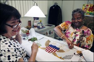 Nereida Rivera, left, and Christine Upchurch embroider a vice presidential flag at the same Defense Logistics Agency in Philadelphia that turns out the presidential flags. The  vice presidential flag takes about 35 days to complete. 