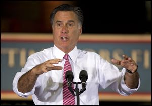 Republican presidential candidate, former Massachusetts Gov. Mitt Romney gestures during a campaign stop at Seilkop Industries in Cincinnati.