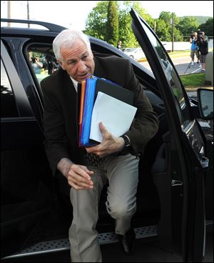 Former Penn State University assistant football coach Jerry Sandusky arrives for the fourth day of his trial at the Centre County Courthouse in Bellefonte, Pa.