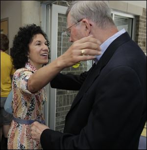 The Rev. Jim Bacik greets Martha Wheeler at Corpus Christi Parish. He has served at the parish since 1982.