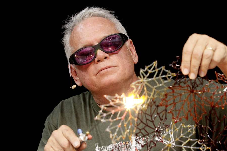 Artist-Robert-Mickelson-works-on-pieces-of-leaves-made-of-glass
