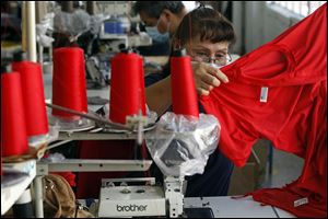 Alicia Luisjuan checks a garment she's worked on at the American Apparel factory in Los Angeles, where 4,500 workers try to prove that clothes can be made for a profit in the United States. 
