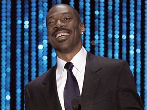 Eddie Murphy proudly shows off his gap between his front teeth.