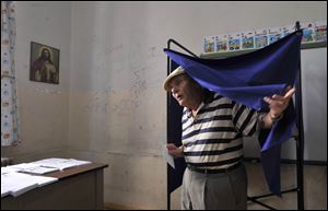 A Greek man leaves the booth after voting during the elections in Thessaloniki.