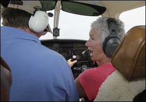 Ellen Wisniewski reacts after flight instructor Steve Crum tells her she passed the test on how to land a plane in an emergency. The Pinch Hitters program teaches novices rudimentary skills.