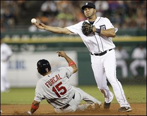 Detroit Tigers shortstop Jhonny Peralta, right, throws to first base to complete a double play as St. Louis Cardinals Rafael Furcal tries to disrupt the throw on a Skip Schumaker groundball in the ninth inning Wednesday in Detroit. The Tigers lost 3-1.