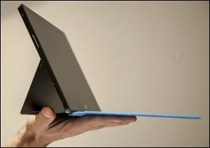 The Microsoft Surface gets thumbs up for its design, but a reviewer finds fault with the device's software interface.