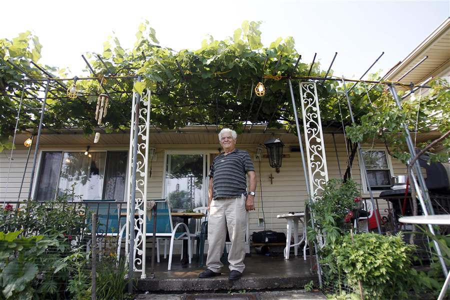 Dimitrios-Mitsopoulos-stands-under-his-patio-veranda