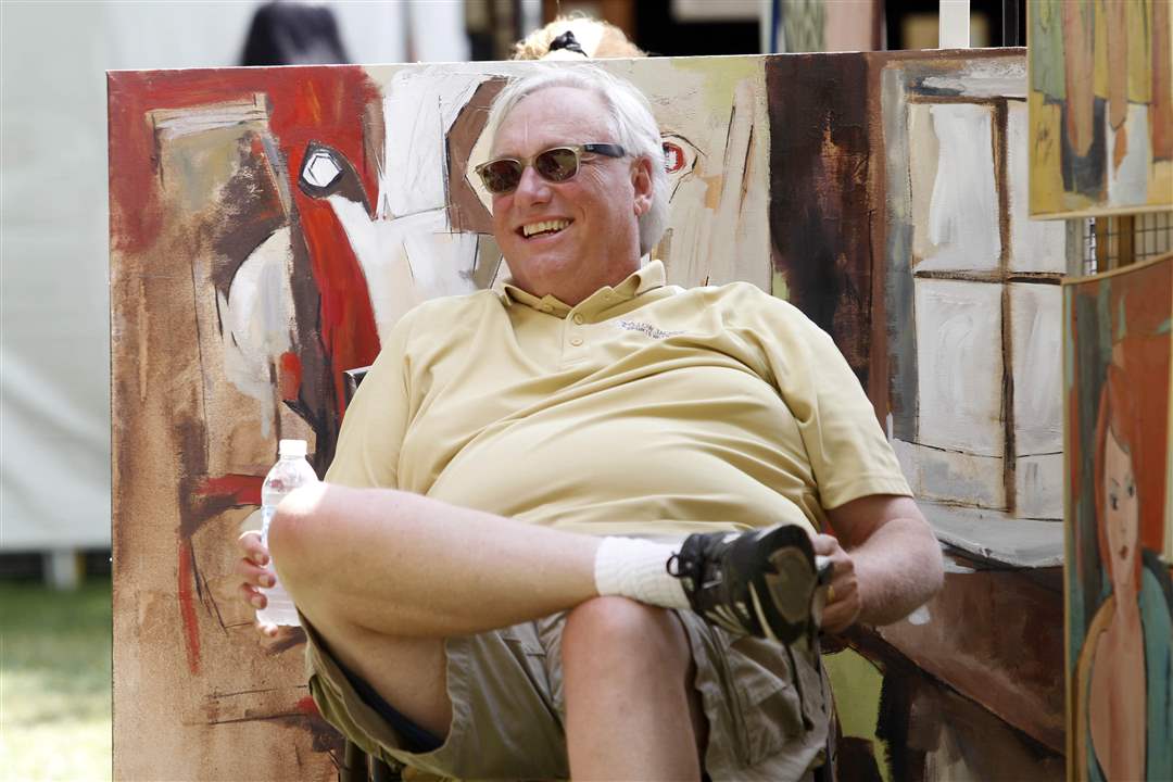 Jim-Funderburg-from-Bryan-sits-near-paintings