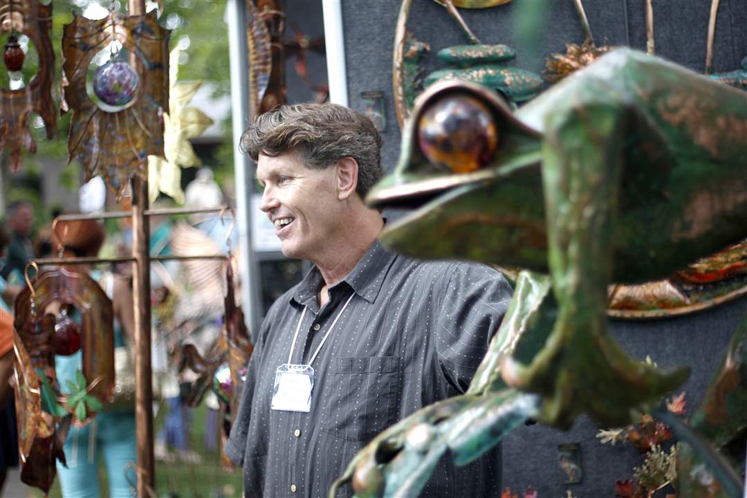 Steve-Anderson-stands-amidst-his-copper-and-bronze-statutes