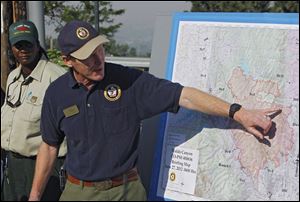 Incident Commander Rich Harvey uses a map as he talks about the Waldo Canyon wildfire during a briefing in Colorado Springs, Colo., on Wednesday. Authorities say it remains too dangerous for them to fully assess the damage from a destructive wildfire threatening Colorado's second-largest city.  