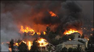 Susan Custer and her husband Gary watch the Waldo Canyon fire. the blaze expanded to the U.S. Air Force Academy campus.