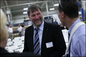 Andreas Nikisch, director of North American operations for MITEC, shares a light moment with Rob Dutkiewicz of Southfield, Mich.
