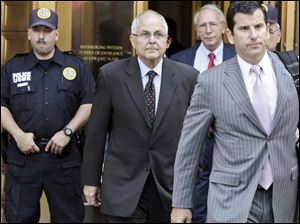 Peter Madoff, second from left, leaves Federal Court on Friday, in New York after pleading guilty to criminal charges.