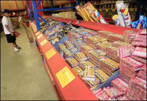 A lone shopper looks over the displays of fireworks on sale at the Olde Glory Fireworks store just north of Denver in unincorporated Adams County, Colo., on Saturday.