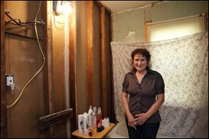 Deborah Smith explains that the bathroom project was started a year ago but had to be put aside after illness sidelined the couple, leaving them with a mostly unfinished room.