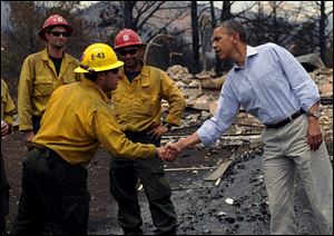 President Barack Obama visits with firefighters at the Mountain Shadows neighborhood damaged by the Waldo Canyon Fire in Colorado Springs, Colo.