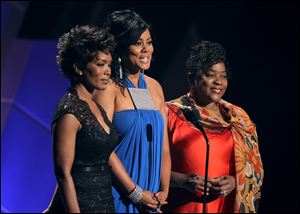 From left, Angela Bassett, Lela Rochon, and Loretta Devine speak during the memorial for Whitney Houston at the BET Awards.