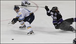 Walleye right wing Evan Rankin takes control of the puck as Reading left wing Dennis McCauley loses his footing.