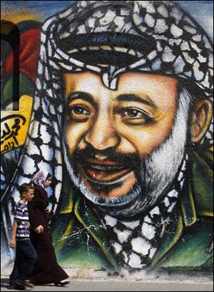 An image of Palestinian leader Yasser Arafat, who died Nov. 11, 2004, fills a wall in Gaza City.