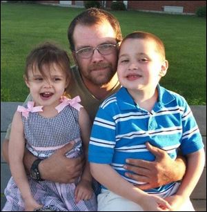Christopher Zimmerman, with children Tawny, 4, and Seth, 7, of Dorcas Road in Springfield Township.  He was killed when a tree fell on his vehicle that he was seated in.
