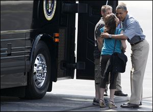 President Obama greets Jeff and Cheri Armes at Toledo Express before they boarded the bus for the ride to the Wolcott House Thursday.