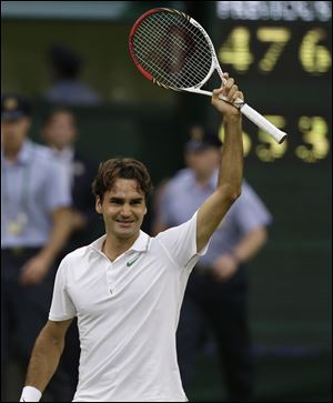 Roger Federer of Switzerland celebrates winning the men's singles final against Andy Murray of Britain at the All England Lawn Tennis Championships at Wimbledon, England, Sunday.