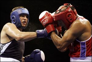 Devin Vargas lands a punch against Morocco's Rachid El Haddak in a heavyweight preliminary bout during the 2004 Summer Olympics in Athens. Vargas won the match. 