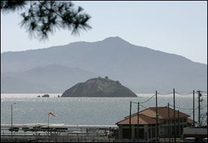 Red Rock Island with Mount Tamalpais in the background is seen in this view taken from Point Richmond, Calif. Red Rock, the island offering a secluded beach, promises of great fishing and stunning views of the San Francisco skyline is up for sale, and at a discounted price.