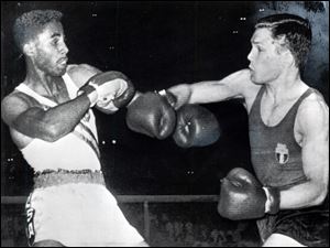 Wilbert ‘Skeeter’ McClure, left, avoids a punch from Italy’s Carmelo Bossi in the 156-pound, light-middleweight final at the 1960 Rome Olympics. McClure rallied in the final round to take a 4-1 victory.