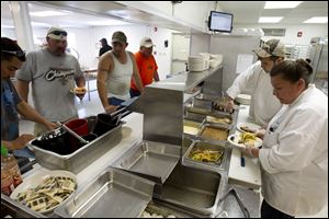 Workers line up for dinner outside Williston, N.D. An estimated 400 recreational vehicles crowded into the city, prompting Williston to pass an ordinance banning camping in city limits.